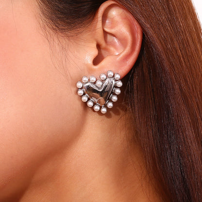 Model Wearing Silver heart hoop earrings with pearl outer ring – waterproof, hypoallergenic by STUD (Shop Till You Drop)