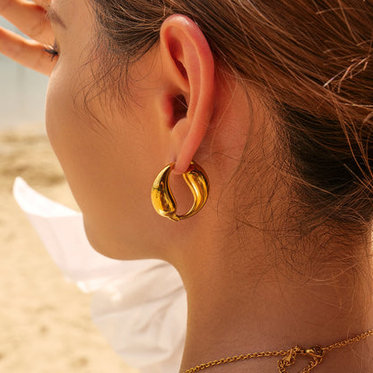 Model Wearing Yin-yang gold hoop earrings with double fish design – 18K gold-plated, waterproof, hypoallergenic by STUD (Shop Till You Drop)
