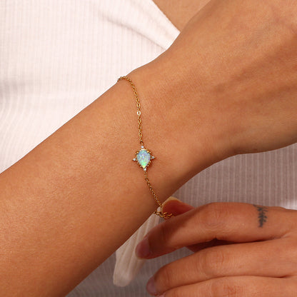 Model Wearing Gold bracelet with blue waterdrop opal charm – vintage design, hypoallergenic by STUD (Shop Till You Drop)