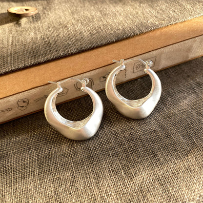 Brushed silver matte hoop earrings with modern irregular shape from STUD