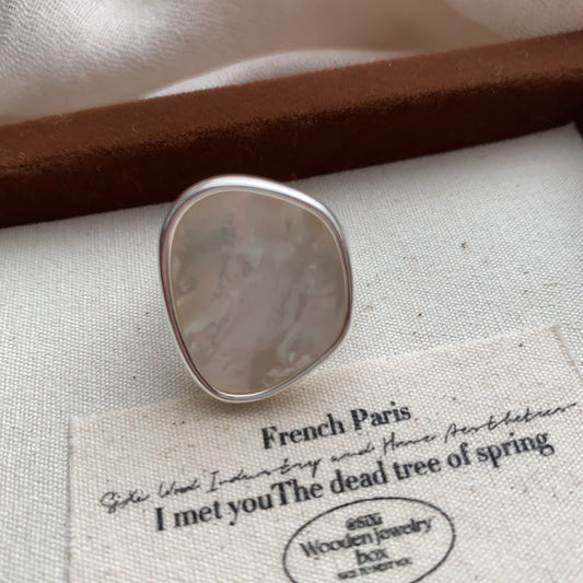 STUD Irregular Mother of Pearl Ring in Silver on neutral fabric with French text card