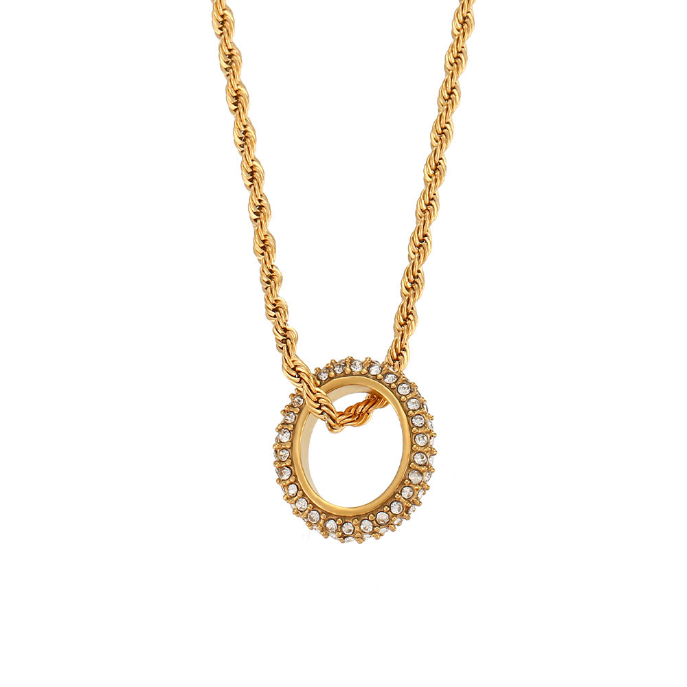Twisted gold rope chain necklace with zircon circle pendant on display