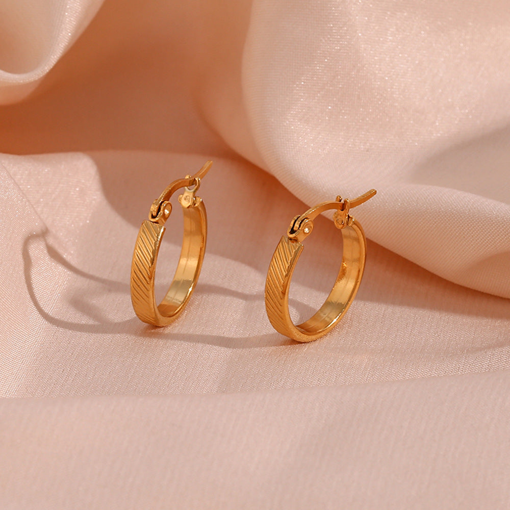 STUD 18K gold-plated slanted textured hoop earrings