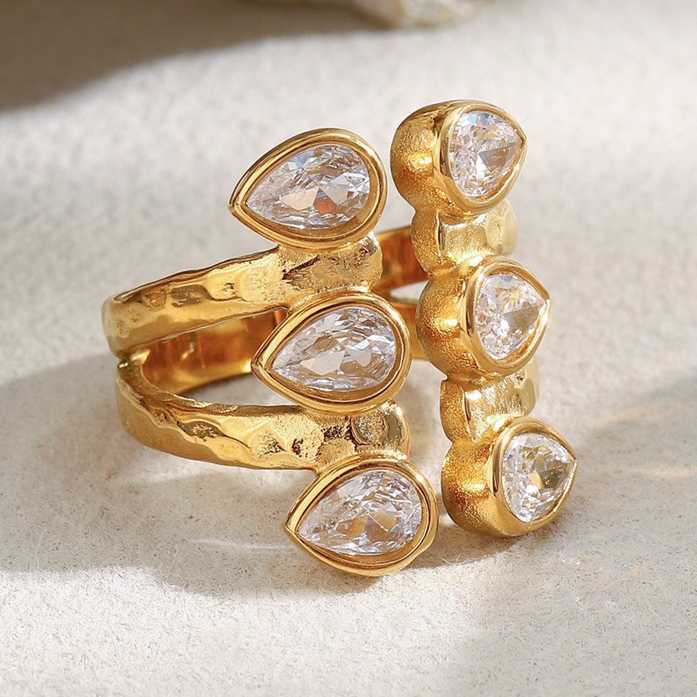 Bold 18K gold-plated open ring with double teardrop zircon stones on hammered stainless steel band – French statement design