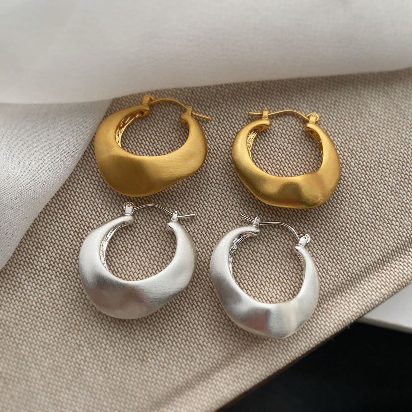Matte gold handcrafted hoop earrings with irregular modern design by STUD