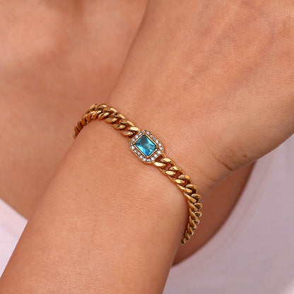 Bold Cuban link chain bracelet with blue zircon stone and pearl accent, 18K gold-plated and adjustable for a modern luxe look