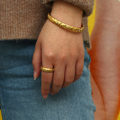Close-up of celestial bangle with star moon and sun motifs