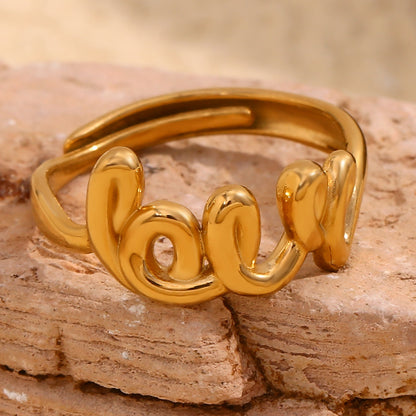 Close up view of LOVE open ring – 18K gold-plated stainless steel with minimalist French design – adjustable statement jewelry by STUD (Shop Till You Drop)