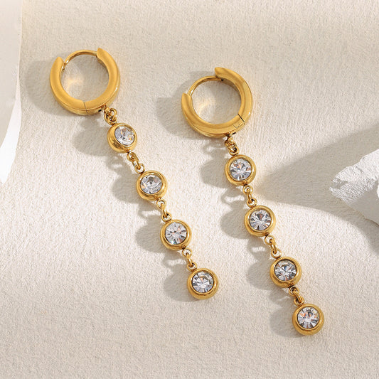 Gold-plated zircon tassel earrings by STUD – minimalist luxury with five sparkling zircon stones on each earring