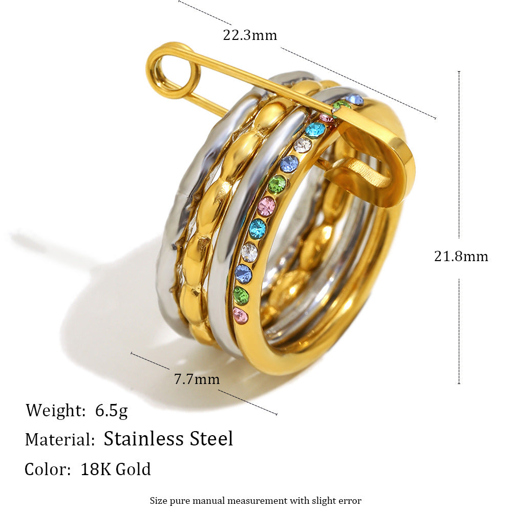 Stacked 18K gold and silver ring with zircon stones and safety pin design