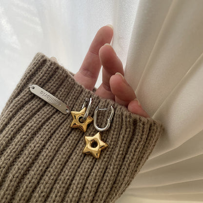 Model Wearing Two-tone star earrings – gold and silver shapes, 18K gold-plated, waterproof, hypoallergenic by STUD (Shop Till You Drop)

