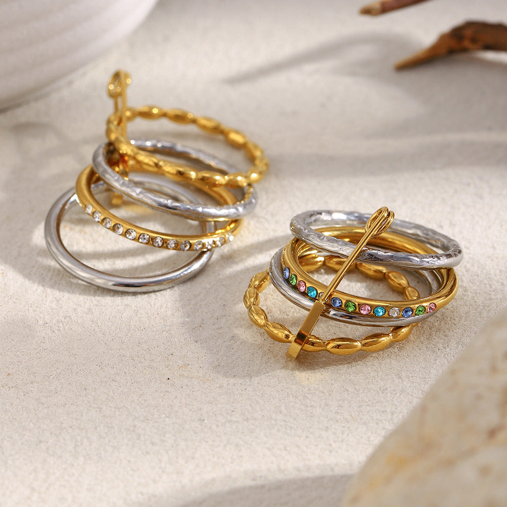 Stacked 18K gold and silver ring with zircon stones and safety pin design