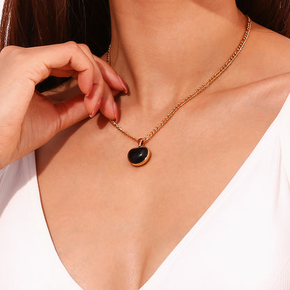 Model wearing Black Onyx Heart Necklace by STUD