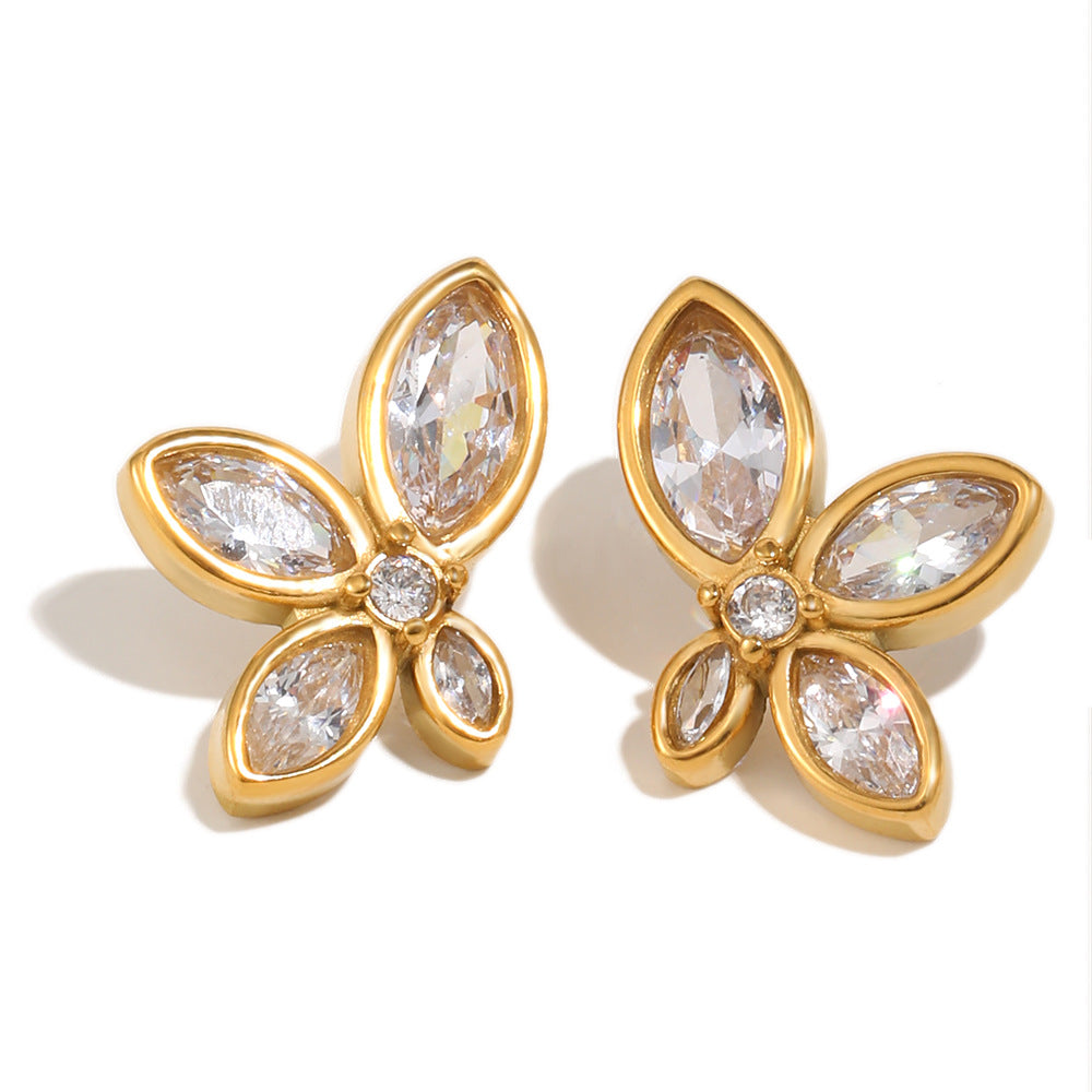 Gold maquise-shaped earrings with clear gemstones on a white background
