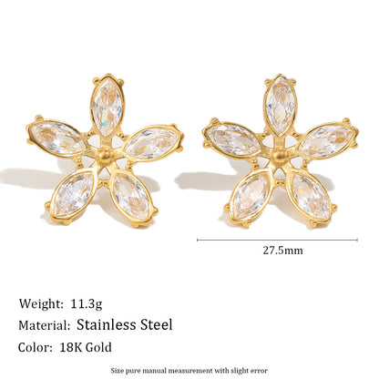 Gold flower-shaped earrings with clear stones on a white background, showing weight, material, and color information.